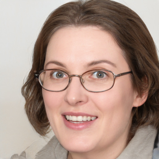 Joyful white adult female with medium  brown hair and blue eyes