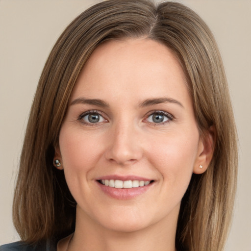 Joyful white young-adult female with long  brown hair and green eyes