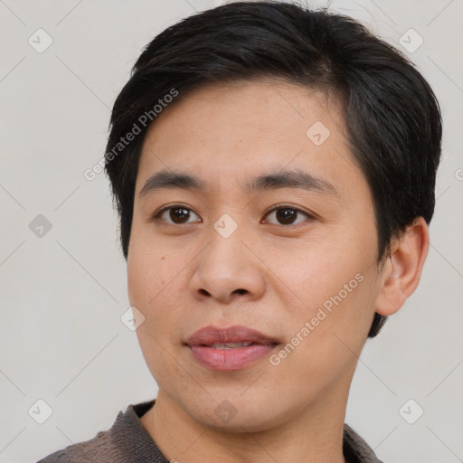 Joyful asian young-adult male with short  brown hair and brown eyes