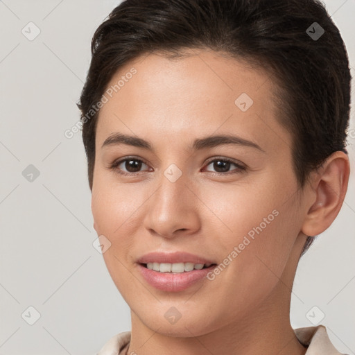 Joyful white young-adult female with short  brown hair and brown eyes