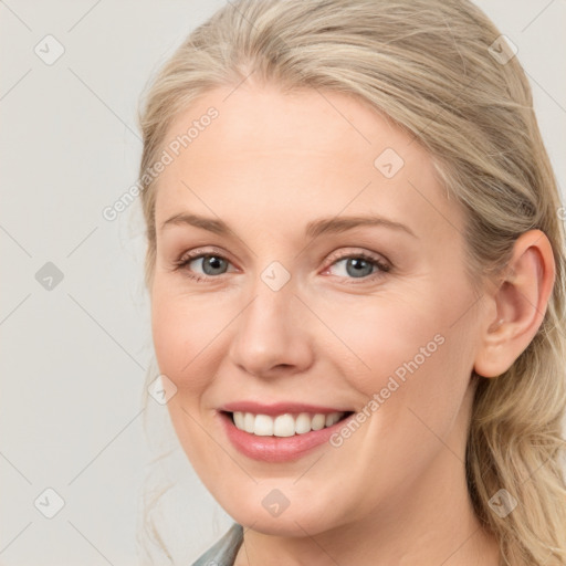 Joyful white young-adult female with medium  brown hair and blue eyes