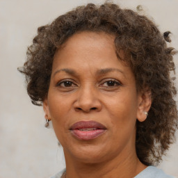 Joyful black adult female with medium  brown hair and brown eyes