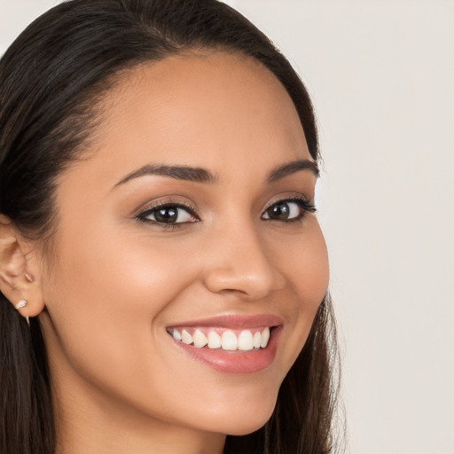 Joyful white young-adult female with long  brown hair and brown eyes