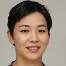 Joyful asian young-adult female with short  black hair and brown eyes