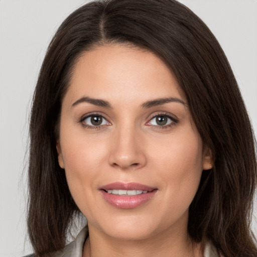 Joyful white young-adult female with long  brown hair and brown eyes