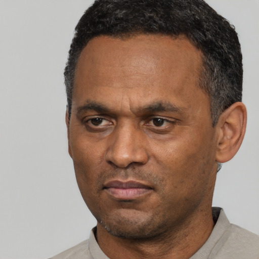 Neutral latino adult male with short  black hair and brown eyes