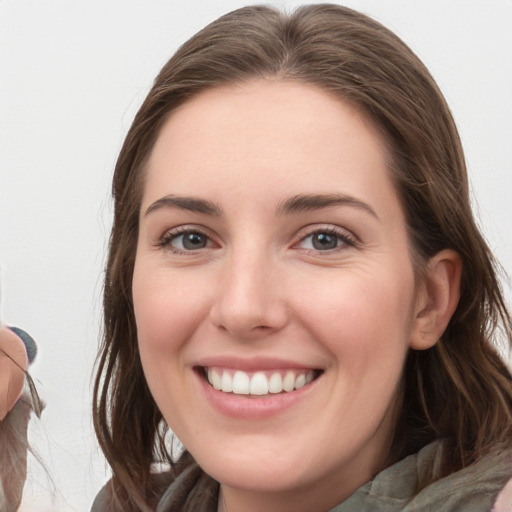 Joyful white young-adult female with medium  brown hair and grey eyes