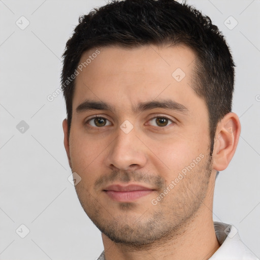 Joyful white young-adult male with short  brown hair and brown eyes