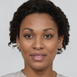 Joyful black young-adult female with short  brown hair and brown eyes