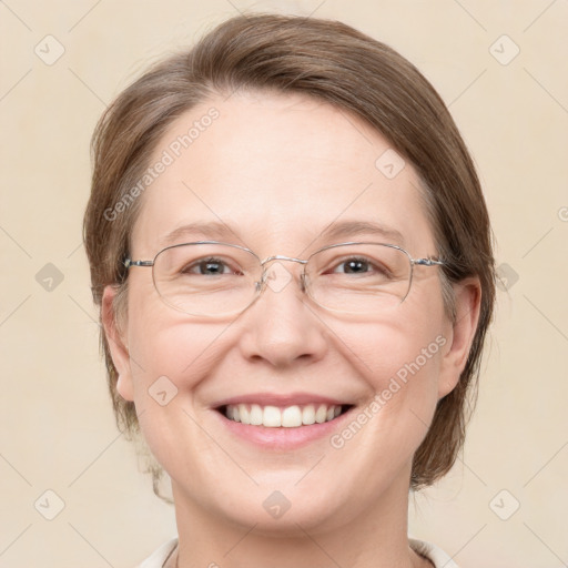 Joyful white adult female with medium  brown hair and blue eyes