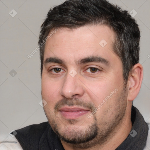 Joyful white adult male with short  brown hair and brown eyes