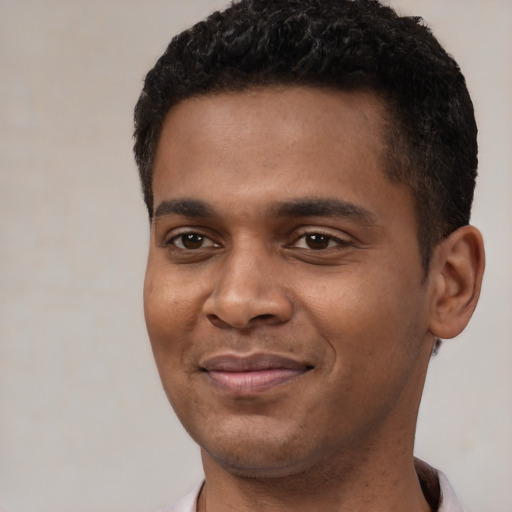 Joyful black young-adult male with short  black hair and brown eyes