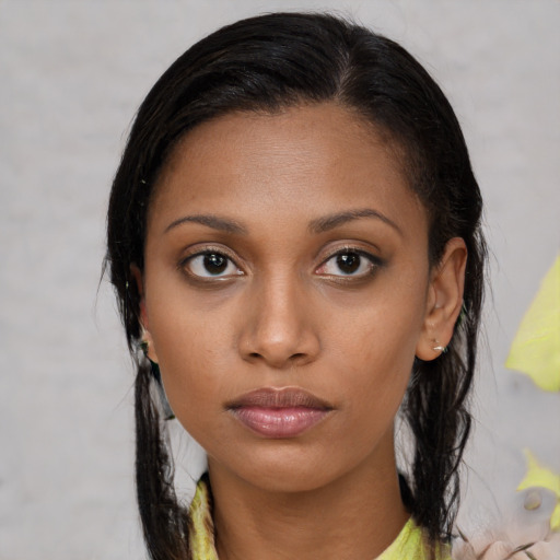 Neutral black young-adult female with medium  brown hair and brown eyes