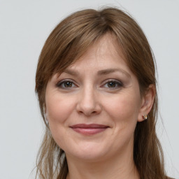 Joyful white adult female with long  brown hair and grey eyes