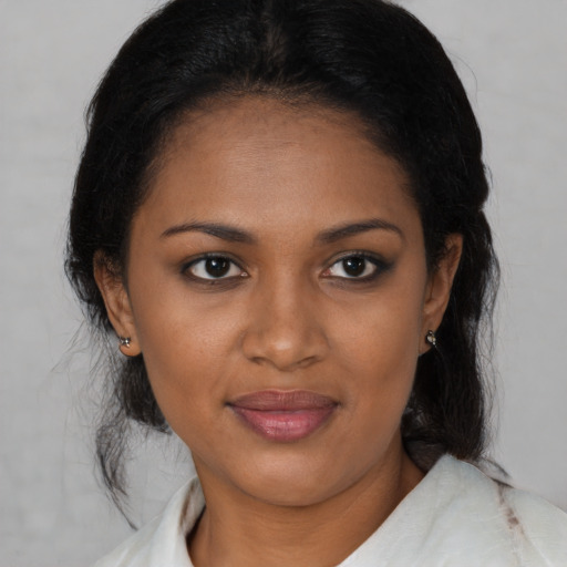 Joyful black young-adult female with medium  brown hair and brown eyes