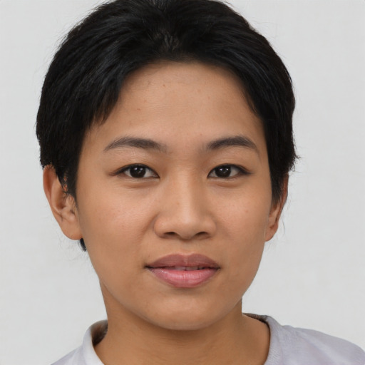 Joyful asian young-adult female with short  black hair and brown eyes