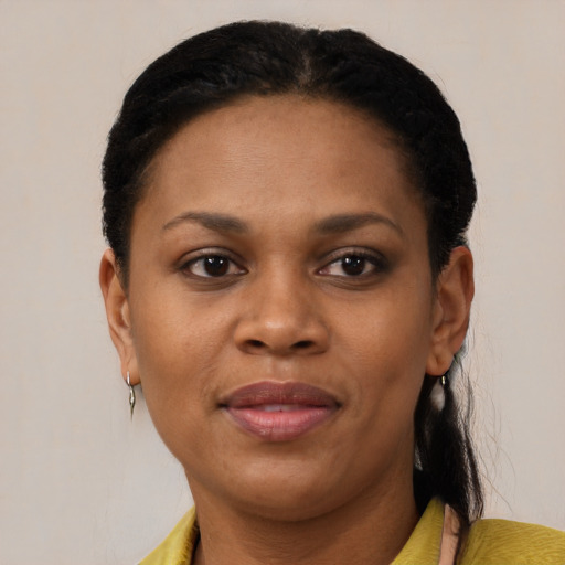 Joyful black adult female with short  brown hair and brown eyes