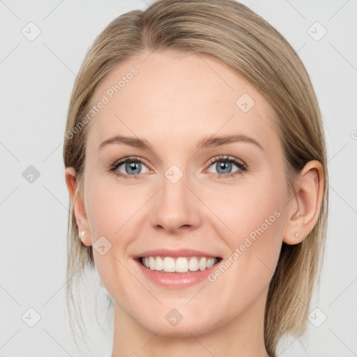 Joyful white young-adult female with long  brown hair and blue eyes