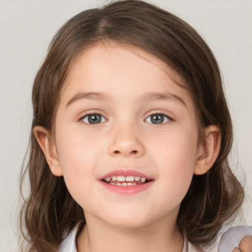 Joyful white child female with medium  brown hair and blue eyes