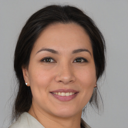 Joyful asian young-adult female with medium  brown hair and brown eyes