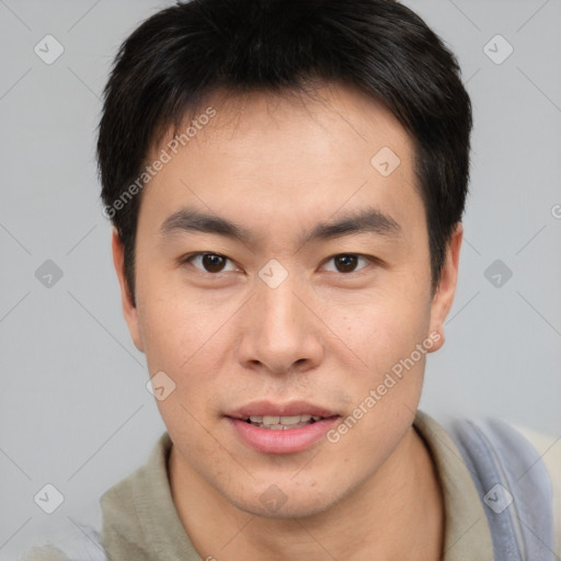 Joyful asian young-adult male with short  brown hair and brown eyes