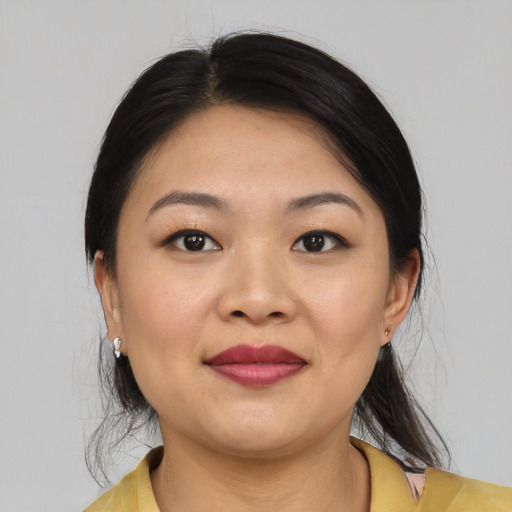 Joyful asian young-adult female with medium  black hair and brown eyes