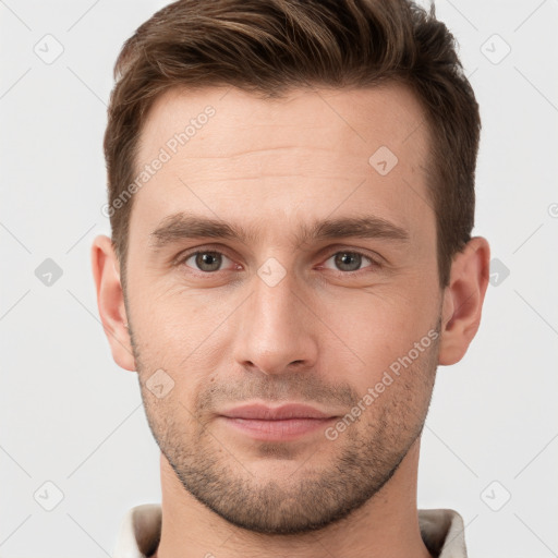 Joyful white young-adult male with short  brown hair and grey eyes