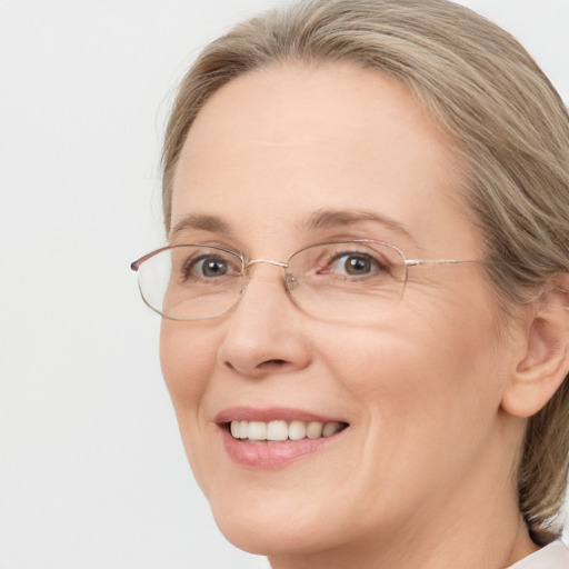 Joyful white adult female with medium  brown hair and blue eyes