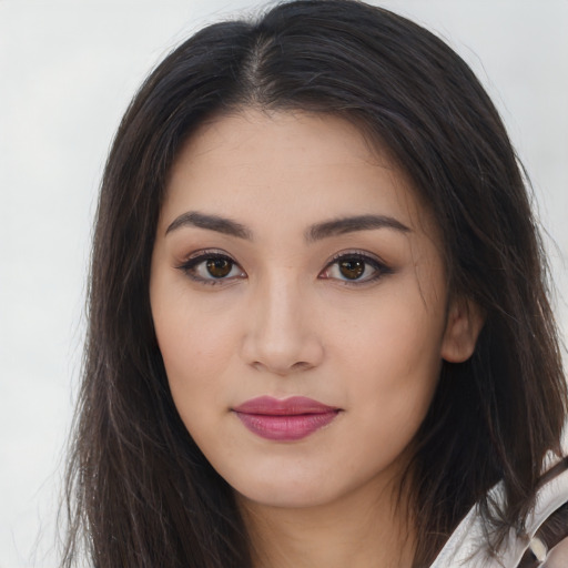 Joyful asian young-adult female with long  brown hair and brown eyes