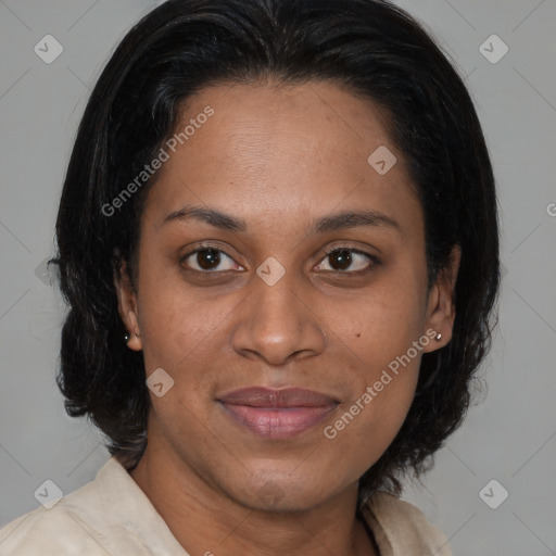 Joyful black adult female with medium  brown hair and brown eyes