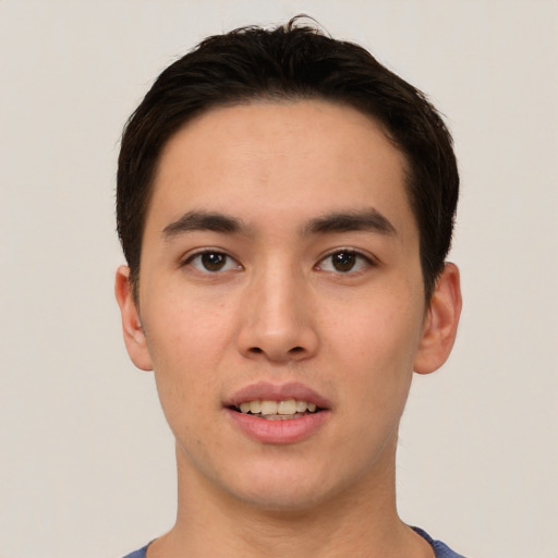 Joyful asian young-adult male with short  brown hair and brown eyes