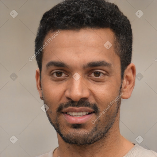 Joyful black young-adult male with short  black hair and brown eyes