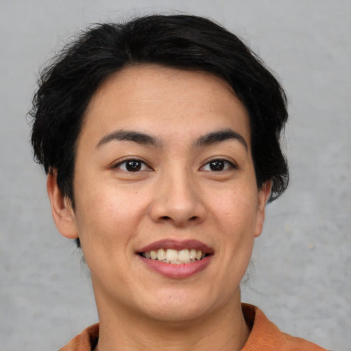 Joyful asian young-adult female with short  black hair and brown eyes