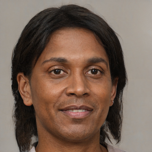 Joyful black adult male with medium  brown hair and brown eyes