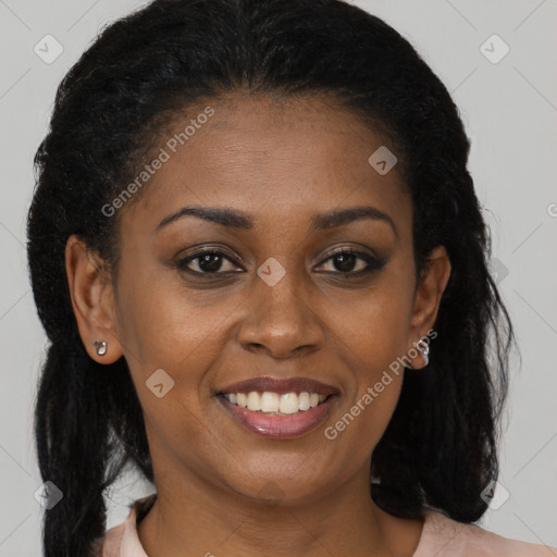 Joyful black young-adult female with long  brown hair and brown eyes