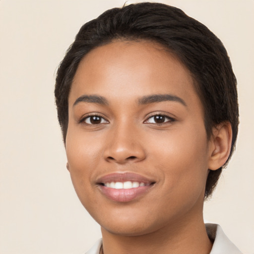 Joyful latino young-adult female with short  black hair and brown eyes