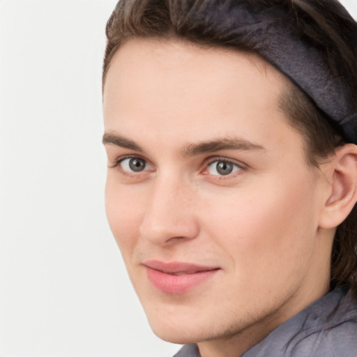 Joyful white young-adult male with medium  brown hair and brown eyes