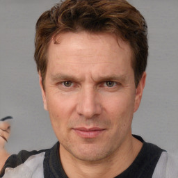 Joyful white adult male with short  brown hair and brown eyes