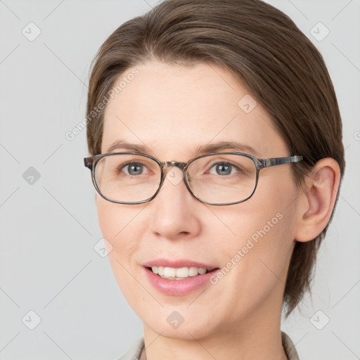 Joyful white young-adult female with medium  brown hair and blue eyes