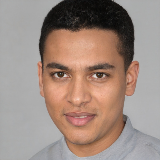 Joyful white young-adult male with short  black hair and brown eyes