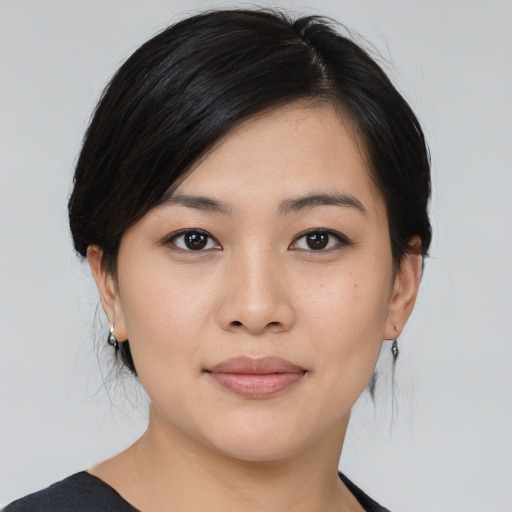 Joyful asian young-adult female with medium  black hair and brown eyes