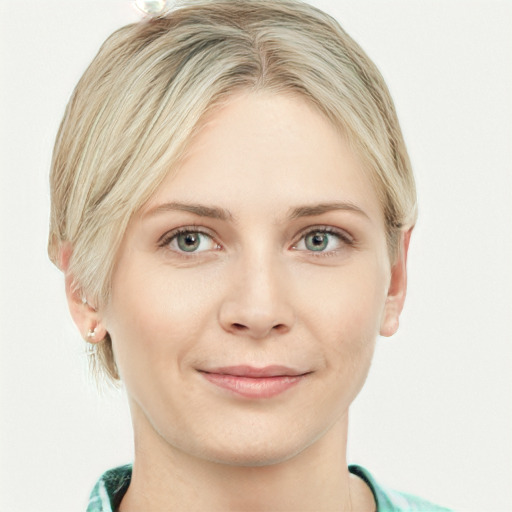 Joyful white young-adult female with short  blond hair and blue eyes