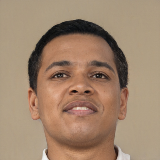 Joyful latino young-adult male with short  black hair and brown eyes