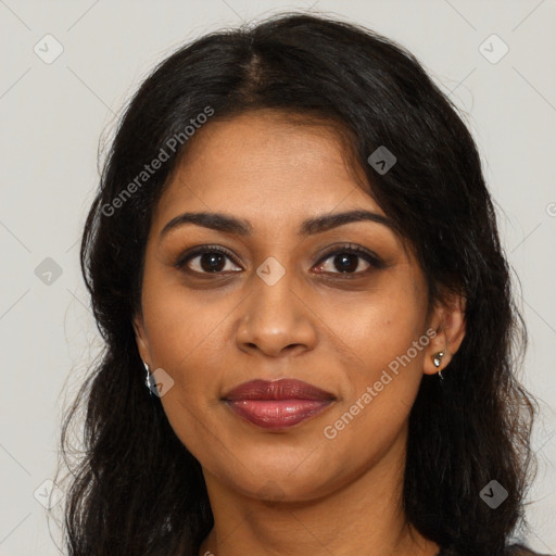 Joyful black young-adult female with long  brown hair and brown eyes