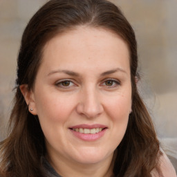 Joyful white adult female with long  brown hair and brown eyes