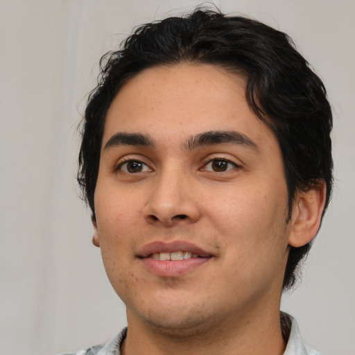 Joyful white young-adult male with short  black hair and brown eyes