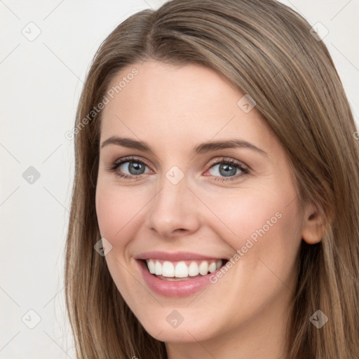 Joyful white young-adult female with long  brown hair and grey eyes