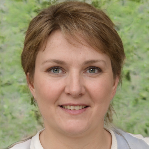 Joyful white adult female with medium  brown hair and green eyes