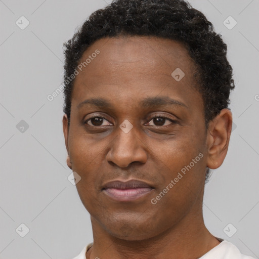 Joyful black adult male with short  brown hair and brown eyes