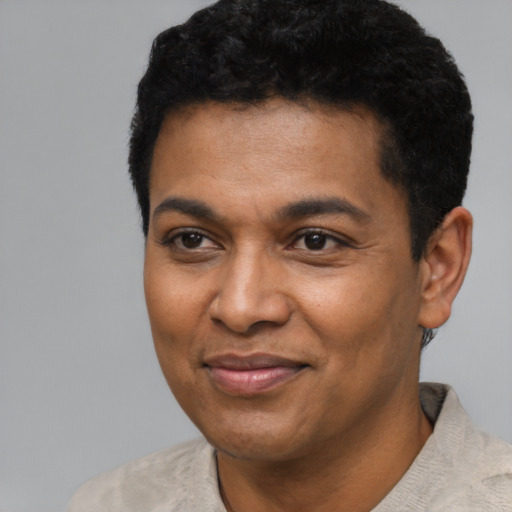 Joyful latino adult male with short  black hair and brown eyes